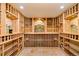 Custom wine cellar features individual bottle storage, unique murals, and tile flooring at 27 Tamarade Dr, Littleton, CO 80127