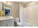 Clean, well-lit bathroom with white tile, gray walls, shower-tub combo, and modern vanity at 8395 E 132Nd Pl, Thornton, CO 80602