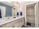 Modern bathroom featuring double sinks, white countertops, and a separate bathtub and toilet at 8395 E 132Nd Pl, Thornton, CO 80602