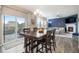 Open-concept dining area flows into a spacious living room with backyard deck access at 8395 E 132Nd Pl, Thornton, CO 80602