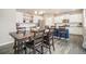 Bright kitchen featuring white cabinetry, a large island, and an open dining area for gatherings at 8395 E 132Nd Pl, Thornton, CO 80602