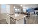 Kitchen island, dining, and a cozy living area with a fireplace in this inviting home at 8395 E 132Nd Pl, Thornton, CO 80602