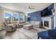 A stylish living room with a gray sectional, fireplace, and a large flat screen TV at 8395 E 132Nd Pl, Thornton, CO 80602