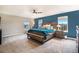 Main bedroom with a ceiling fan, two windows, carpet, and a king bed with end tables at 8395 E 132Nd Pl, Thornton, CO 80602