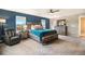 Spacious main bedroom featuring plush carpeting, en-suite bathroom, large windows, and stylish furniture at 8395 E 132Nd Pl, Thornton, CO 80602