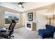 Bright office with a large window, electric fireplace, and comfortable seating for an ideal workspace at 8395 E 132Nd Pl, Thornton, CO 80602