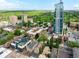 Scenic aerial view of condos near downtown with beautiful tree coverage, a park and city skyline at 33 S Ogden St, Denver, CO 80209