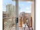 Cozy balcony view with railing and chair and view of surrounding cityscape through sliding glass doors at 33 S Ogden St, Denver, CO 80209