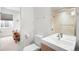 Modern bathroom features a sleek vanity, toilet, and a glass-enclosed shower with tiled walls at 33 S Ogden St, Denver, CO 80209