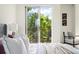 Bright bedroom featuring a balcony with lush green views, creating a tranquil space at 33 S Ogden St, Denver, CO 80209