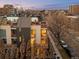 Contemporary home with multiple balconies, modern architecture, and beautifully landscaped front yard at dusk at 33 S Ogden St, Denver, CO 80209