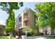 Contemporary condo building with multiple balconies surrounded by trees in a vibrant neighborhood at 33 S Ogden St, Denver, CO 80209