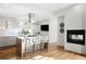 Contemporary kitchen with island, white countertops, gas cooktop, pendant hood, and comfortable seating at 33 S Ogden St, Denver, CO 80209