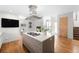 Modern kitchen island with gas cooktop, seating, stainless hood, and sleek cabinetry at 33 S Ogden St, Denver, CO 80209