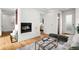 Open living room with hardwood floors, a fireplace, and modern decor at 33 S Ogden St, Denver, CO 80209