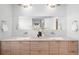 Elegant bathroom with double sinks, wood cabinets, and modern lighting at 33 S Ogden St, Denver, CO 80209