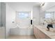 Luxurious bathroom with tub, double sink vanity, and modern finishes at 33 S Ogden St, Denver, CO 80209
