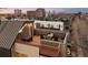 Spacious roof deck with outdoor furniture, awning, and city views, perfect for entertaining guests at 33 S Ogden St, Denver, CO 80209