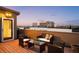 Beautiful rooftop deck with outdoor furniture and stunning city views at 33 S Ogden St, Denver, CO 80209