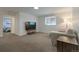 Finished basement featuring a comfortable seating area, carpet, and natural light at 2184 S Braun Way, Lakewood, CO 80228