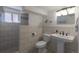 Bright bathroom featuring a tiled shower and updated fixtures at 2184 S Braun Way, Lakewood, CO 80228