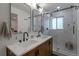 Modern bathroom with double sinks, marble countertops, and tiled shower at 2184 S Braun Way, Lakewood, CO 80228