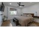 Comfortable bedroom featuring hardwood floors, neutral decor, and a large window at 2184 S Braun Way, Lakewood, CO 80228