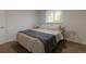 Bedroom featuring carpet, large window, and a cozy bed at 2184 S Braun Way, Lakewood, CO 80228
