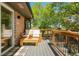 Cozy outdoor deck featuring wood furnishings and lovely views of the well-maintained yard at 2184 S Braun Way, Lakewood, CO 80228