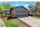 Exterior view of brick home with well-kept lawn, garage, and newer siding at 2184 S Braun Way, Lakewood, CO 80228