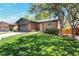Charming brick home with a well-manicured lawn and mature trees shading the front yard at 2184 S Braun Way, Lakewood, CO 80228