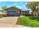 Beautiful front yard with lush green grass, mature trees, and a freshly painted exterior at 2184 S Braun Way, Lakewood, CO 80228