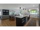 Open kitchen featuring a center island, white cabinets, and modern stainless steel appliances at 2184 S Braun Way, Lakewood, CO 80228