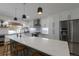 Bright kitchen featuring a large island, stainless steel appliances, and modern pendant lighting at 2184 S Braun Way, Lakewood, CO 80228