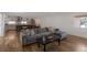Spacious living area featuring an open layout with hardwood floors and a comfortable sofa at 2184 S Braun Way, Lakewood, CO 80228