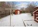 Backyard featuring snow, an outdoor shed, patio area and shrubs at 3860 Dudley St, Wheat Ridge, CO 80033