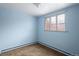 Bedroom with carpeted floor, baseboard heater, and natural light from the window at 3860 Dudley St, Wheat Ridge, CO 80033