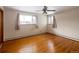 Bright bedroom with hardwood floors, ceiling fan and two large windows at 3860 Dudley St, Wheat Ridge, CO 80033