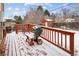 Exterior shot of deck, featuring a grill, seating and snow covered floor at 3860 Dudley St, Wheat Ridge, CO 80033