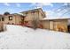 Back exterior elevation with snow, a deck and patio space at 3860 Dudley St, Wheat Ridge, CO 80033