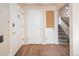 Bright foyer with wooden floors, three doors, and stairs going to the upper level at 3860 Dudley St, Wheat Ridge, CO 80033