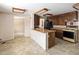 Country kitchen with vintage appliances, wood cabinets, and neutral countertops at 3860 Dudley St, Wheat Ridge, CO 80033