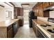 Bright kitchen features vintage appliances, lots of cabinet space, and tile flooring at 3860 Dudley St, Wheat Ridge, CO 80033