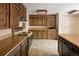 Country-style kitchen with wood cabinets, a peninsula island, and classic appliances at 3860 Dudley St, Wheat Ridge, CO 80033