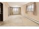 Bright living room with carpeted floor, large window, and natural light streaming through the curtains at 3860 Dudley St, Wheat Ridge, CO 80033