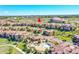 Aerial view of a townhouse community featuring a pool, clubhouse, and well-maintained landscaping at 9351 Viaggio Way, Highlands Ranch, CO 80126