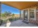 Covered balcony with stone walls, a railing, and a view of the neighborhood at 9351 Viaggio Way, Highlands Ranch, CO 80126