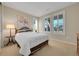 Bright bedroom with large windows and shutters, a queen-size bed, and a decorative painting at 9351 Viaggio Way, Highlands Ranch, CO 80126