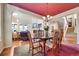 Elegant dining room with views into living room and beautiful chandelier lighting at 9351 Viaggio Way, Highlands Ranch, CO 80126