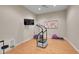Exercise room with hardwood floors, a vibration plate, a TV, and workout accessories at 9351 Viaggio Way, Highlands Ranch, CO 80126